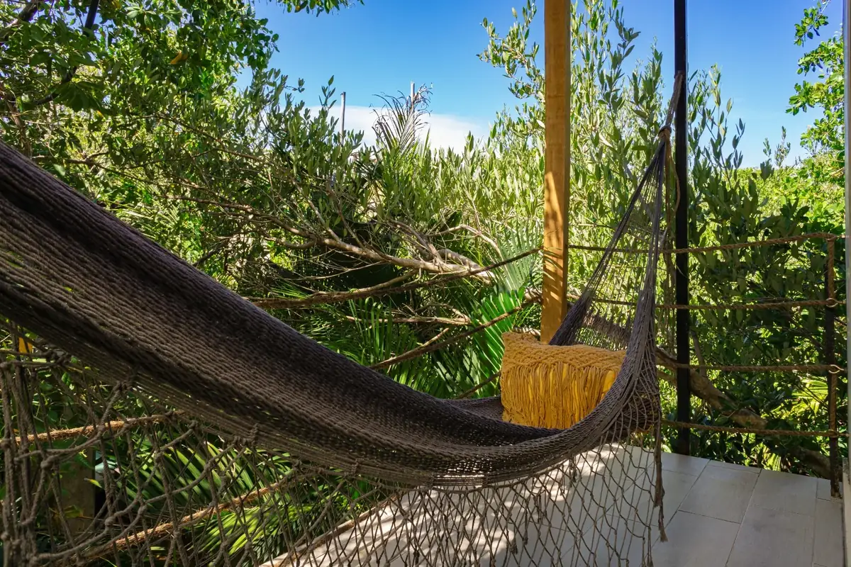 Balcony hammock surrounded by greenery at Sunset Tulum